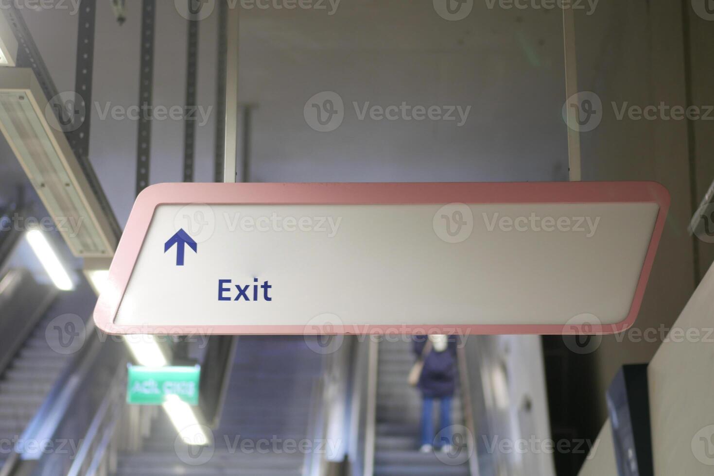 Directional Exit Sign prominently displayed in a Modern Transit Station for commuters photo