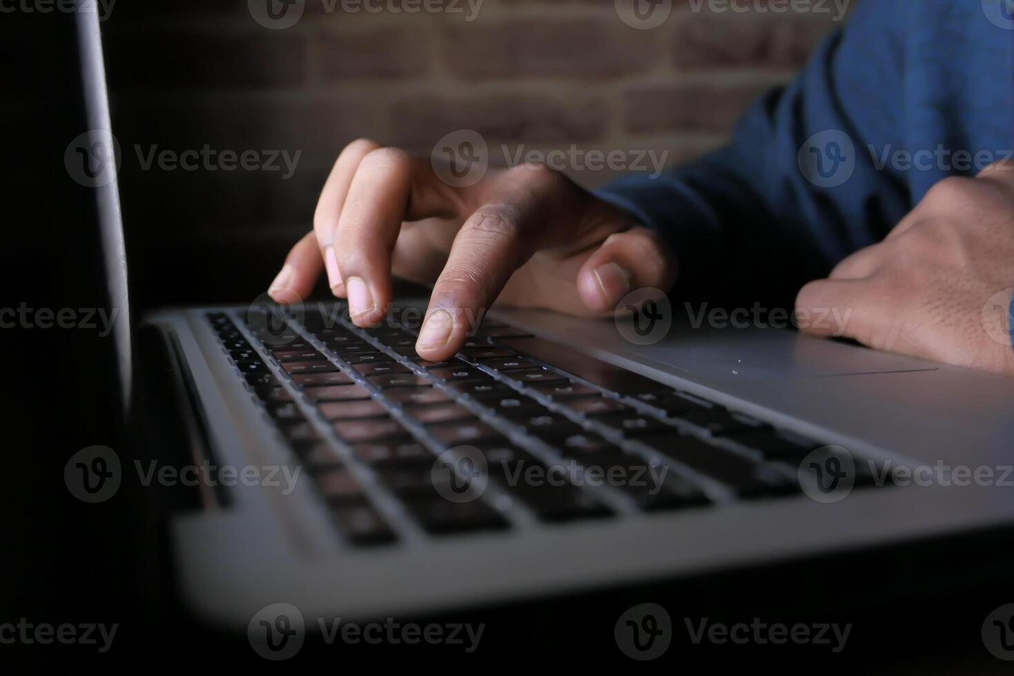 CloseUp of Hands Actively Typing on a Laptop Keyboard in a Busy Work Environment photo