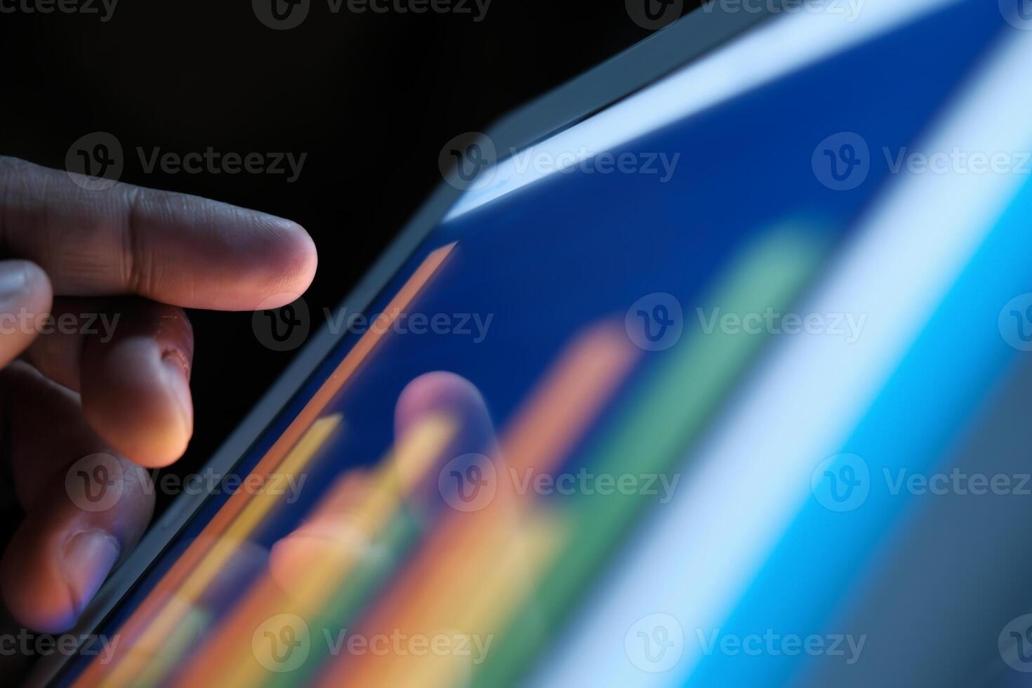 A hand interacting with a data visualization on a tablet screen, highlighting modern technology photo