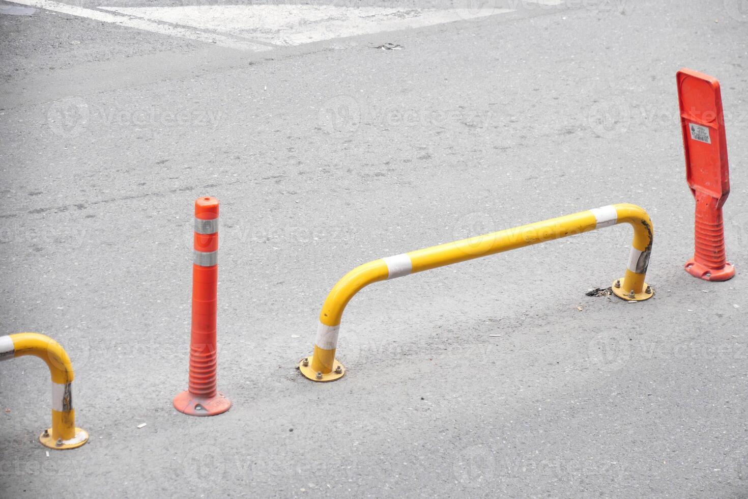 Traffic barriers and orange cones are placed on a busy city street for safety and organization photo