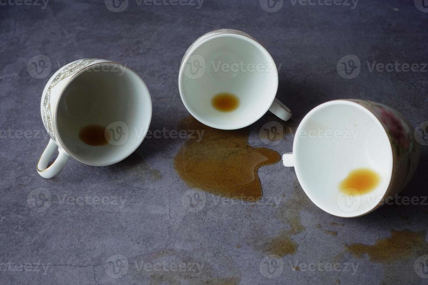 Spilled Tea An Artistic Arrangement Featuring Three Empty and Beautifully Crafted Cups photo