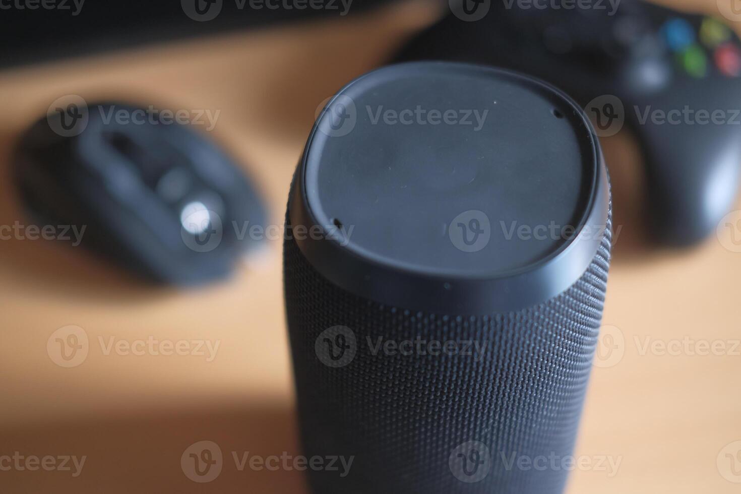 A detailed closeup view of a Portable Bluetooth Speaker accompanied by various Gaming Accessories photo
