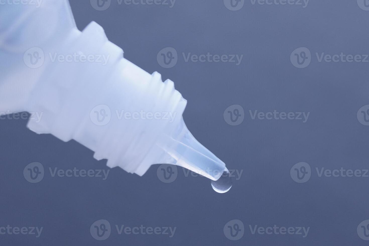 A closeup of a droplet forming from a liquid container, showcasing moisture and detail photo