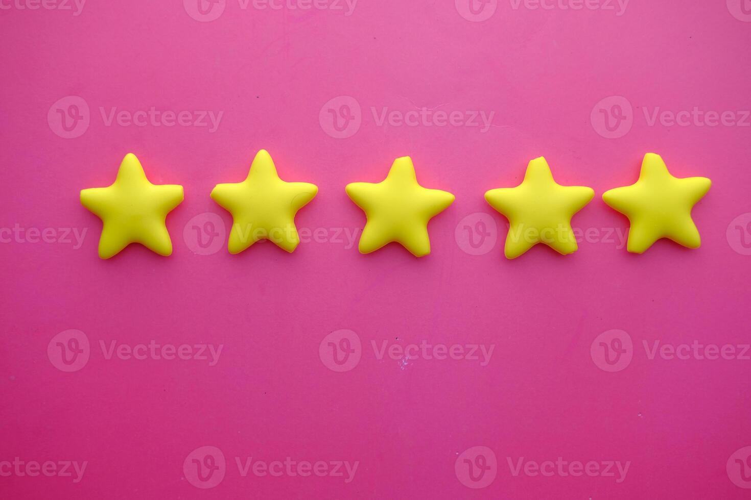 Beautiful Yellow Star Shapes adorning a lovely Pink Background, perfect for Creative Projects photo