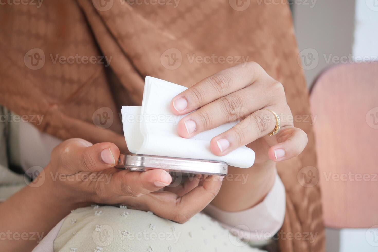 cleaning mobile phone display for preventing virus photo