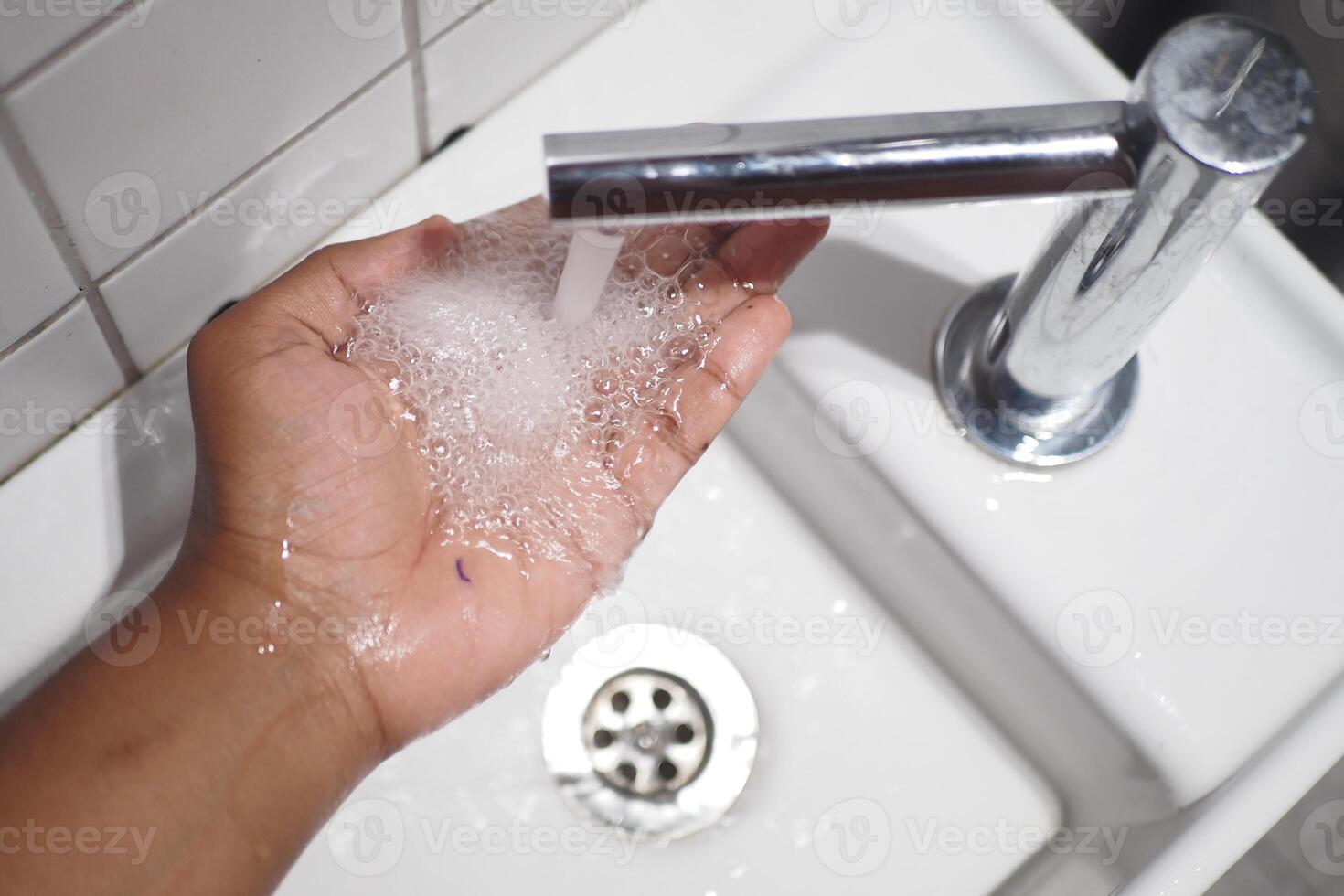 Washing Your Hands Effectively Under a Contemporary Sink Faucet for Optimal Hygiene Benefits photo