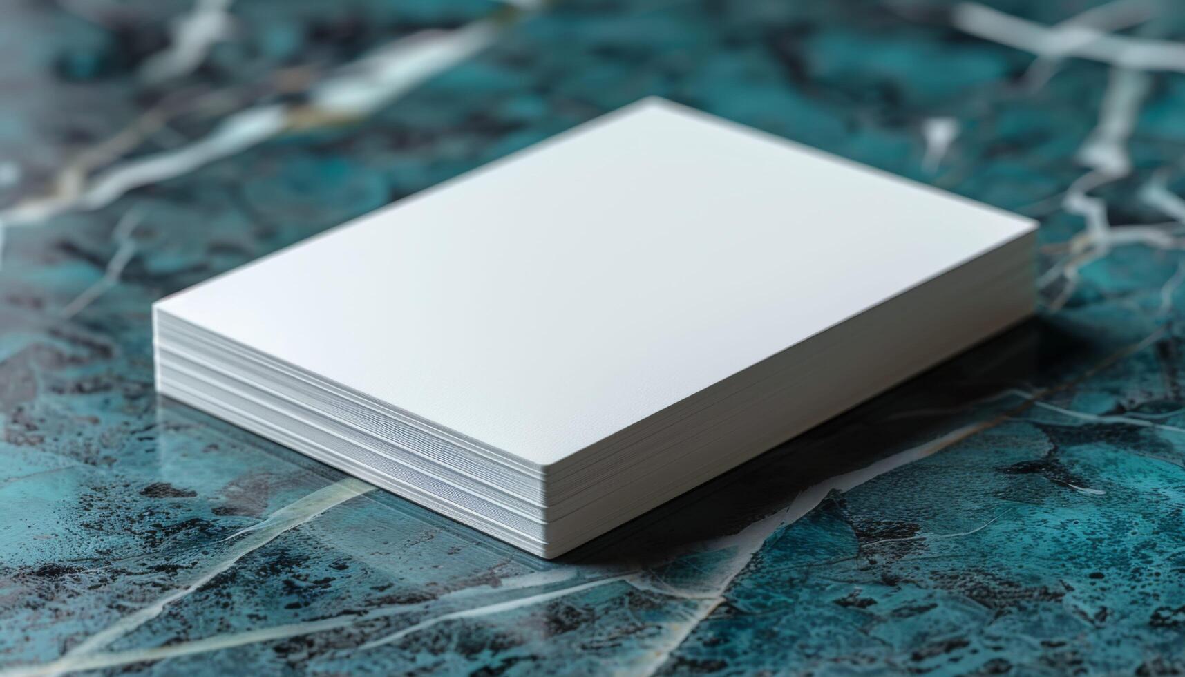 A stack of white paper is on a blue surface photo