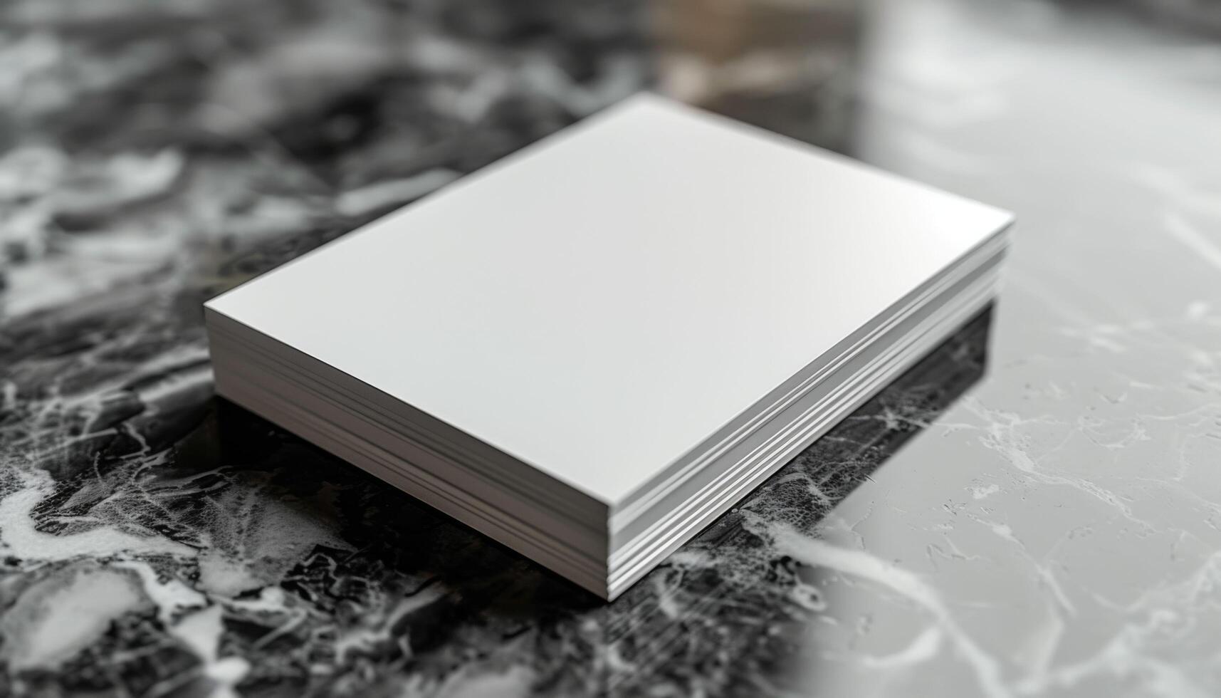A stack of white paper is on a marble countertop photo
