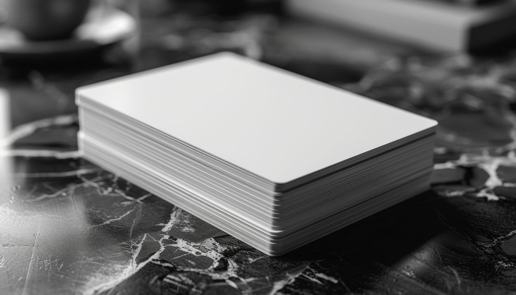 A stack of white cards is on a table photo