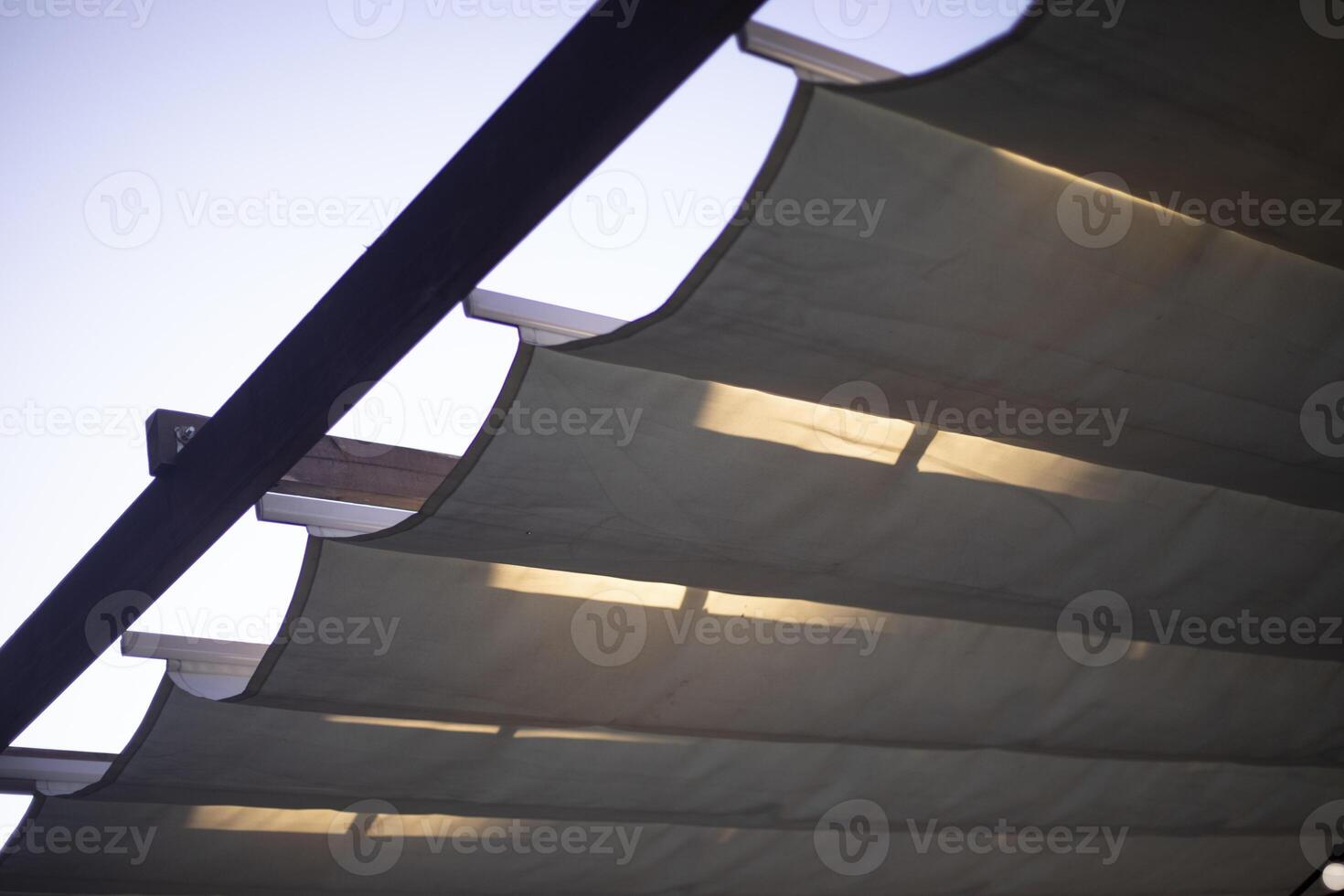 A porch made of wood and fabric. Lights on the veranda. Details of the building. photo