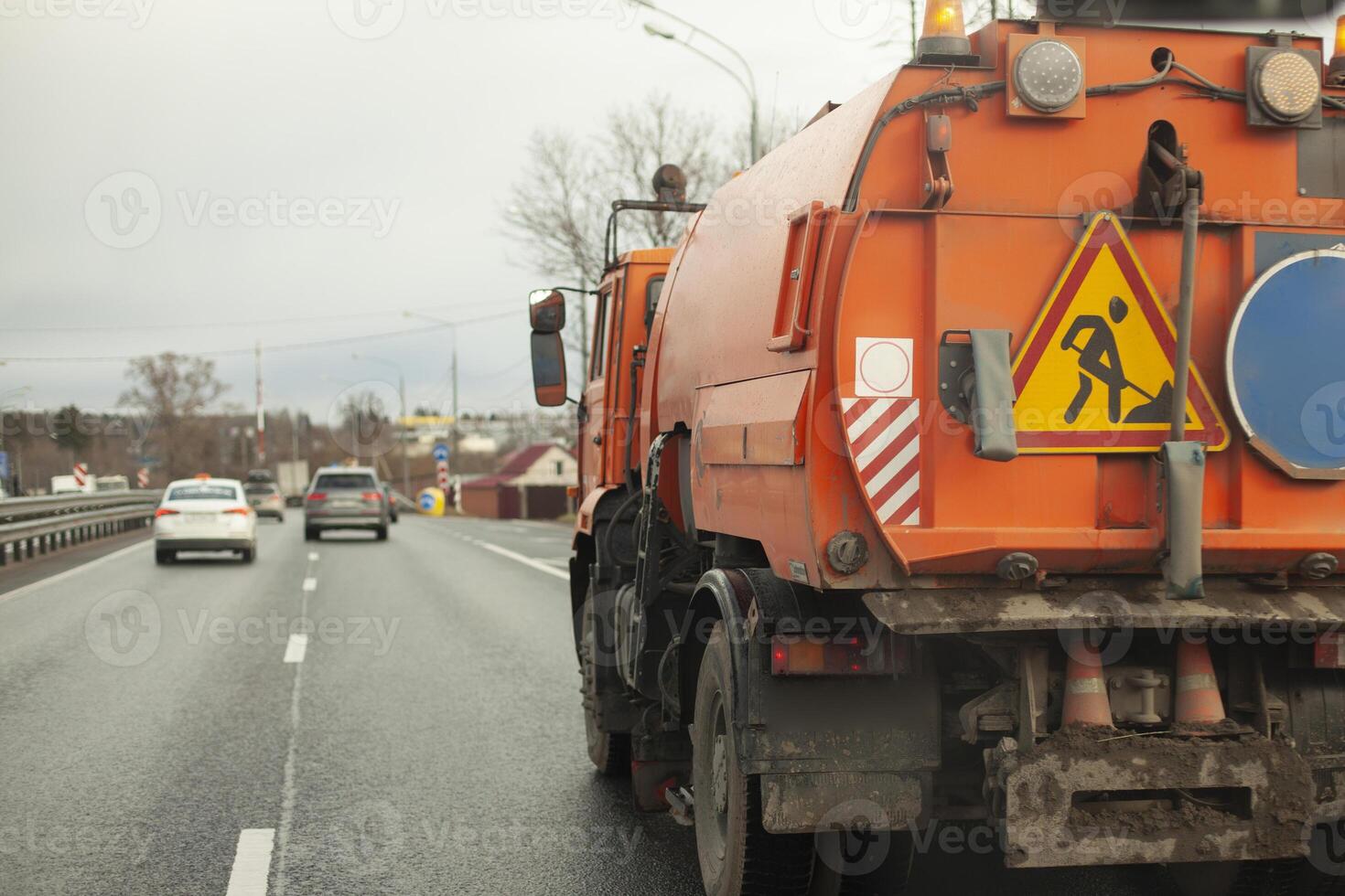 Harvesting equipment. Special transport for cleaning in the city. Orange truck. photo