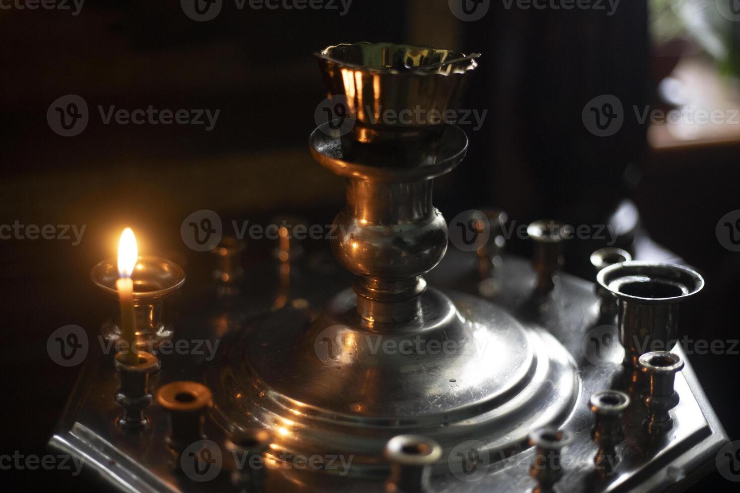 Candles in the Church. Wax candles burning in the dark. Religious atmosphere. photo