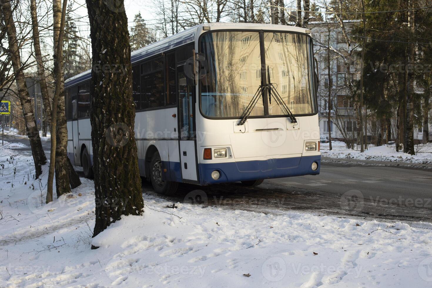 Public transport in winter. Bus parking. Old car. photo