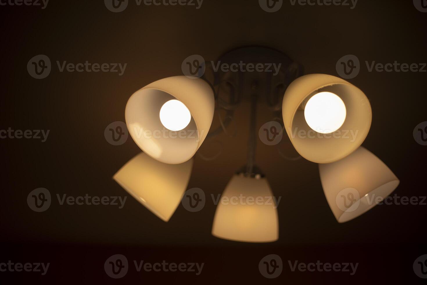 Lamp on the ceiling. Chandelier in the interior. Warm light from the lamp. photo