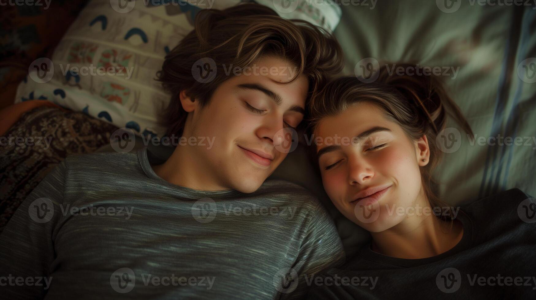 Young couple peacefully sleeps side by side on cozy bed portrait image. Teenagers faces relaxed and content picture photorealistic photography. Togetherness concept photo realistic