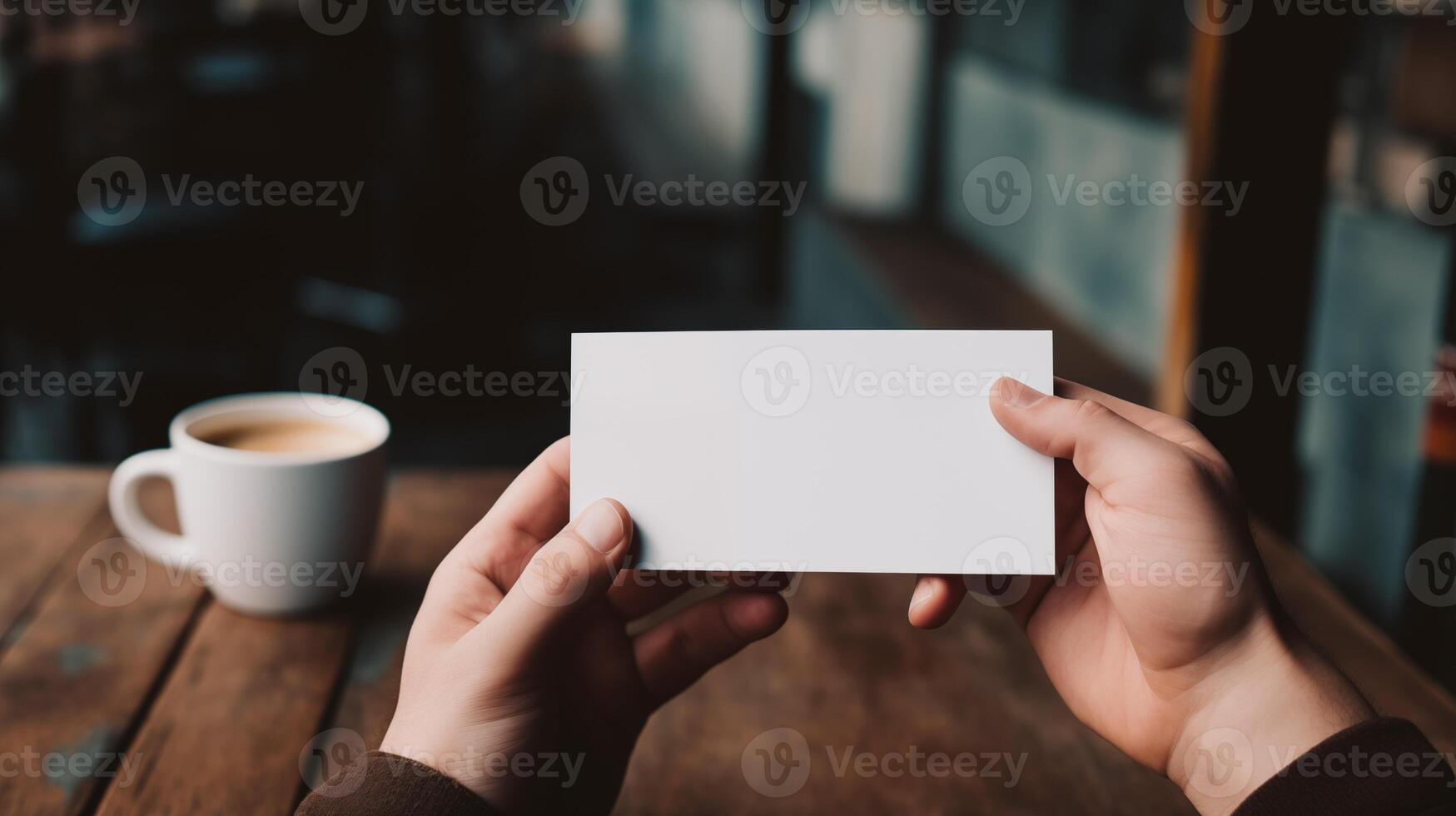 Hands holding blank card mockup with coffee on wooden table. Warm casual setting. Voucher coupon template advertising image. Coffee break. Businesscard mock up product photorealistic photo
