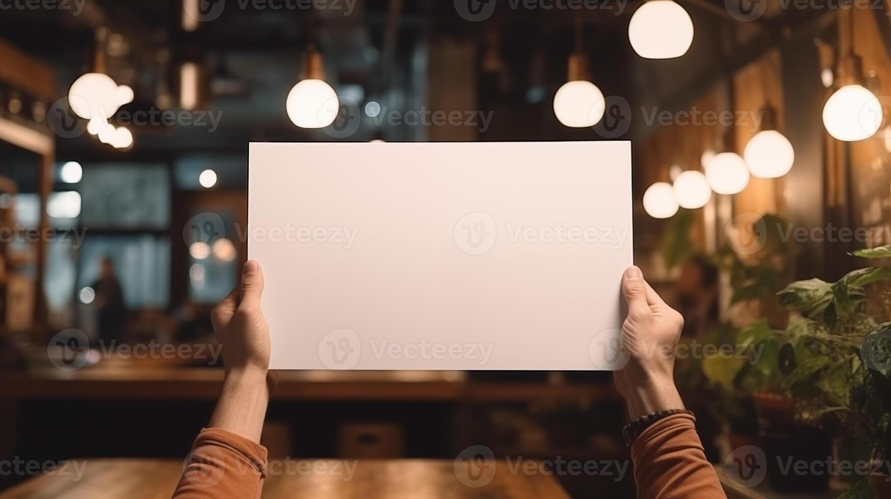 Hands holding blank card mockup with ambient lighting in cafe. Restaurant branding template advertising image. Warm atmosphere with hanging lights mock up product photorealistic photo