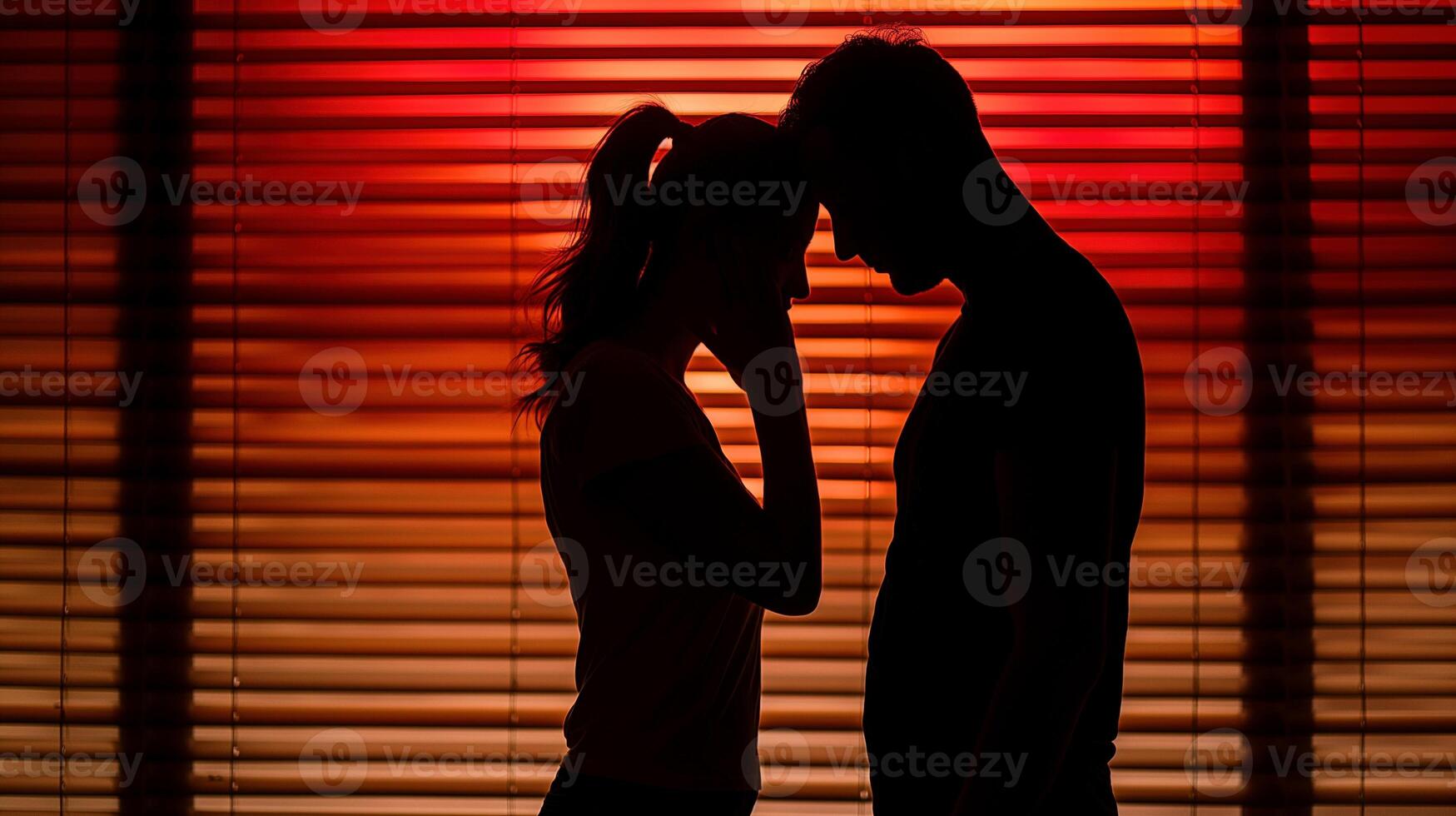 Couple stands in deep red light filtering through window blinds image. Woman man foreheads touching in moment of quiet intimacy photography. Togetherness concept photorealistic photo