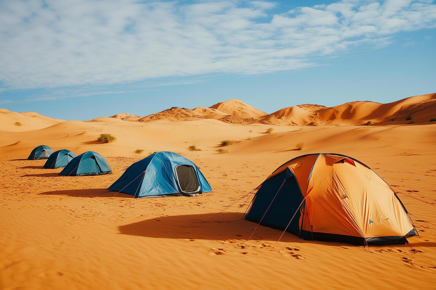 Camping tents standing on sand in desert landscape photo