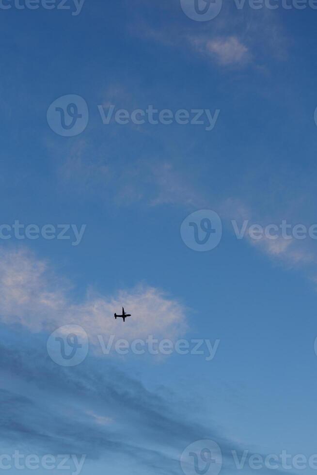 Airplane gliding through a serene evening sky photo
