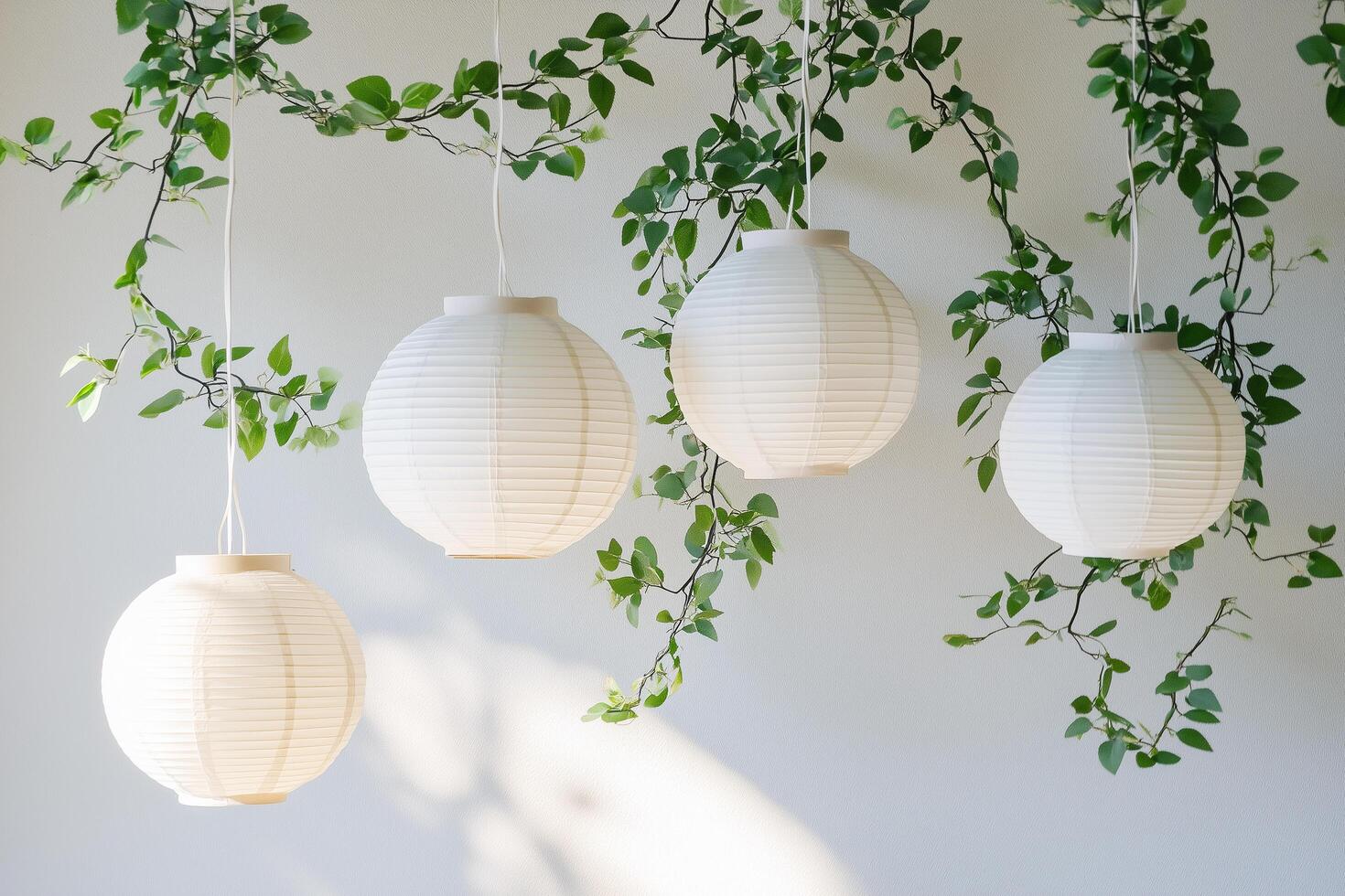 White paper lanterns hanging with vine plants creating festive atmosphere photo