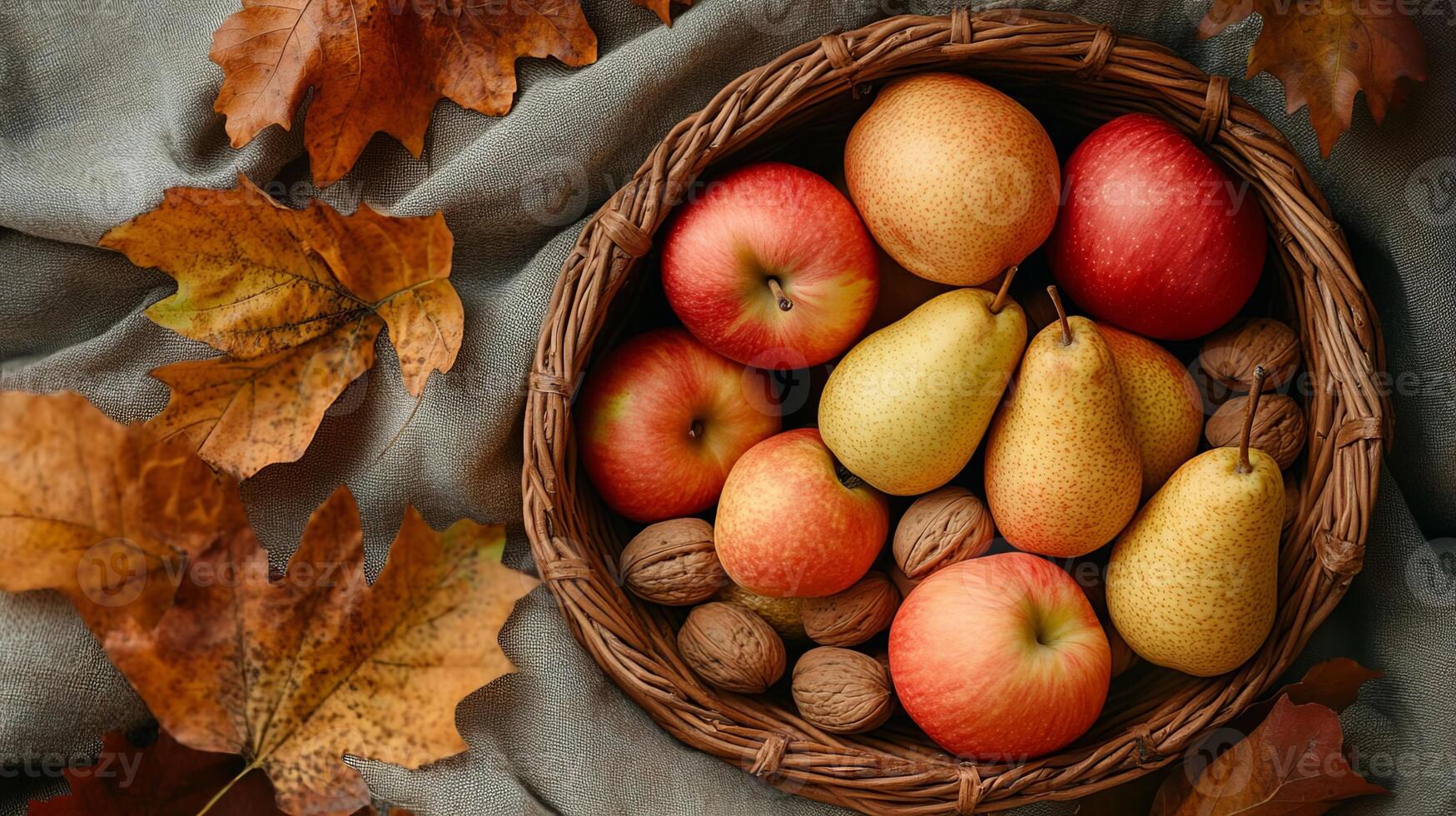 Autumn Harvest Apples Pears and Walnuts in Wicker Basket with Fall Leaves photo