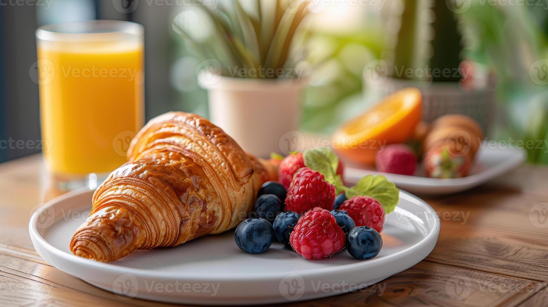A croissant and fruit on a plate on a table photo