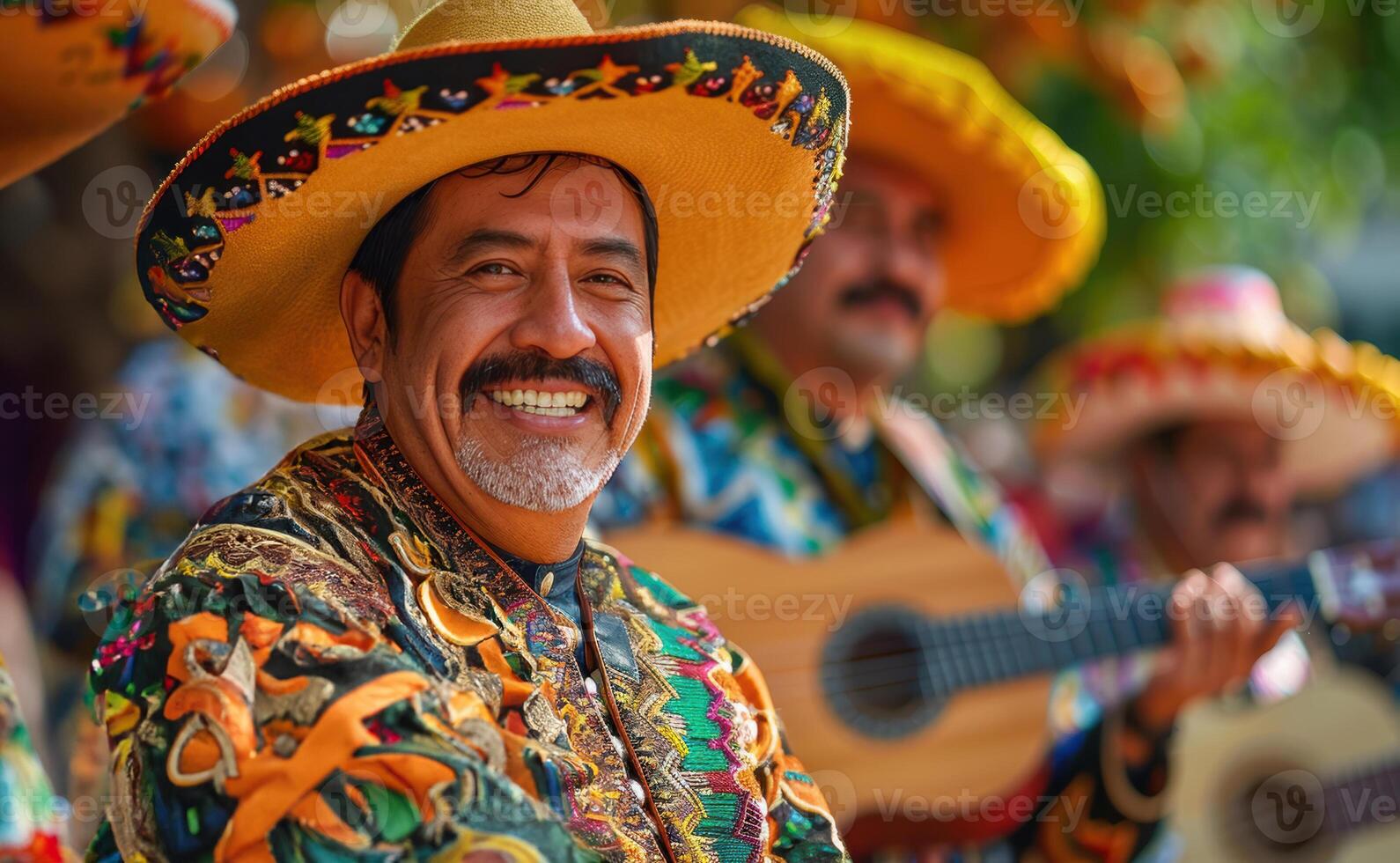 A man in a mexican costume playing guitar photo