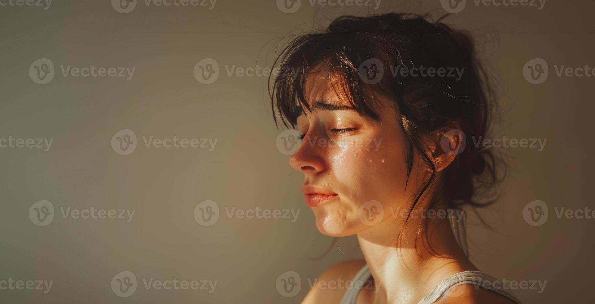 A woman is crying while looking down photo