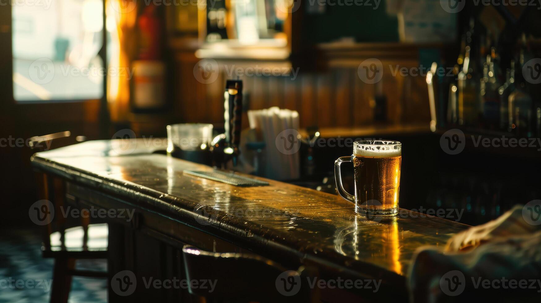 A beer glass sits on a bar in a restaurant photo