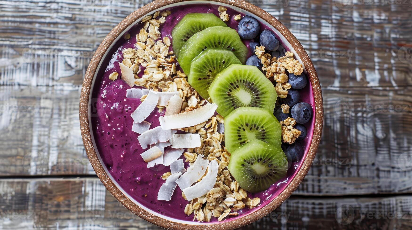 Blueberry smoothie bowl with kiwi and coconut flakes photo