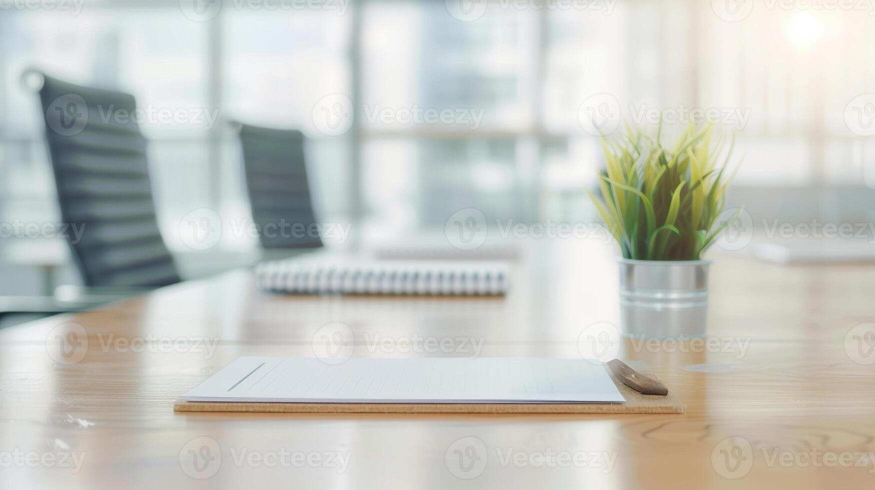 A conference table with a pen and notepad photo