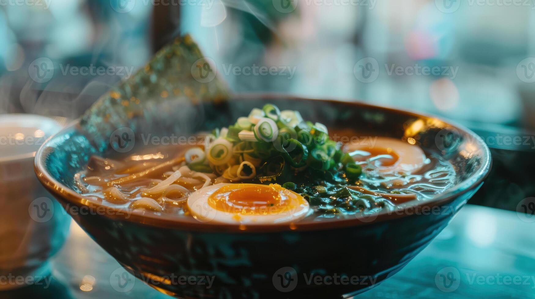A bowl of ramen with an egg and a cup of coffee photo