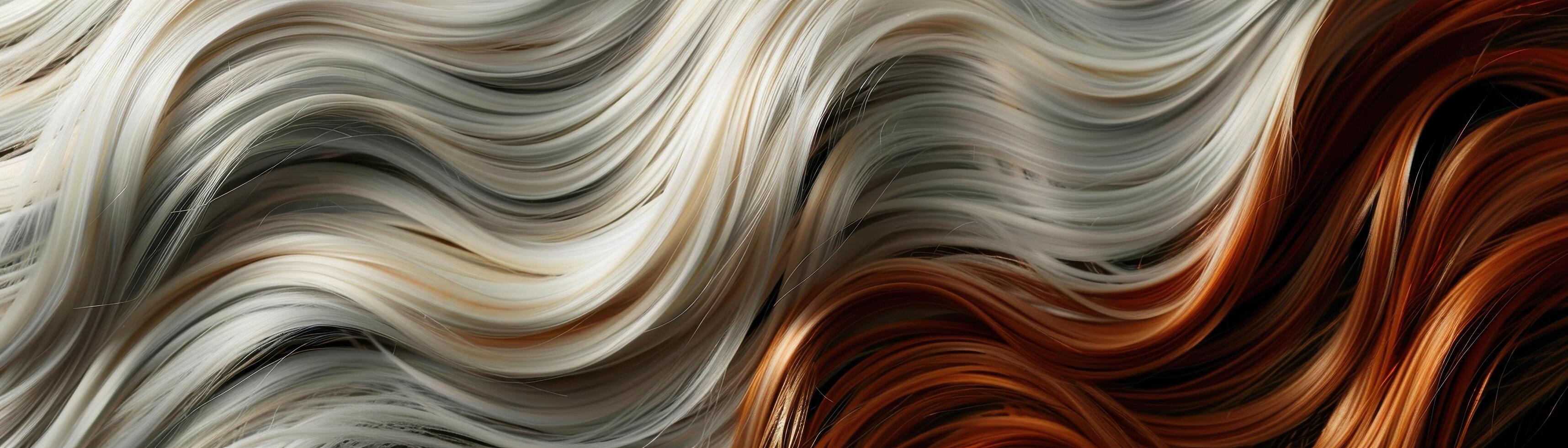 Blonde and auburn hair strands flowing in a smooth undulating pattern photo
