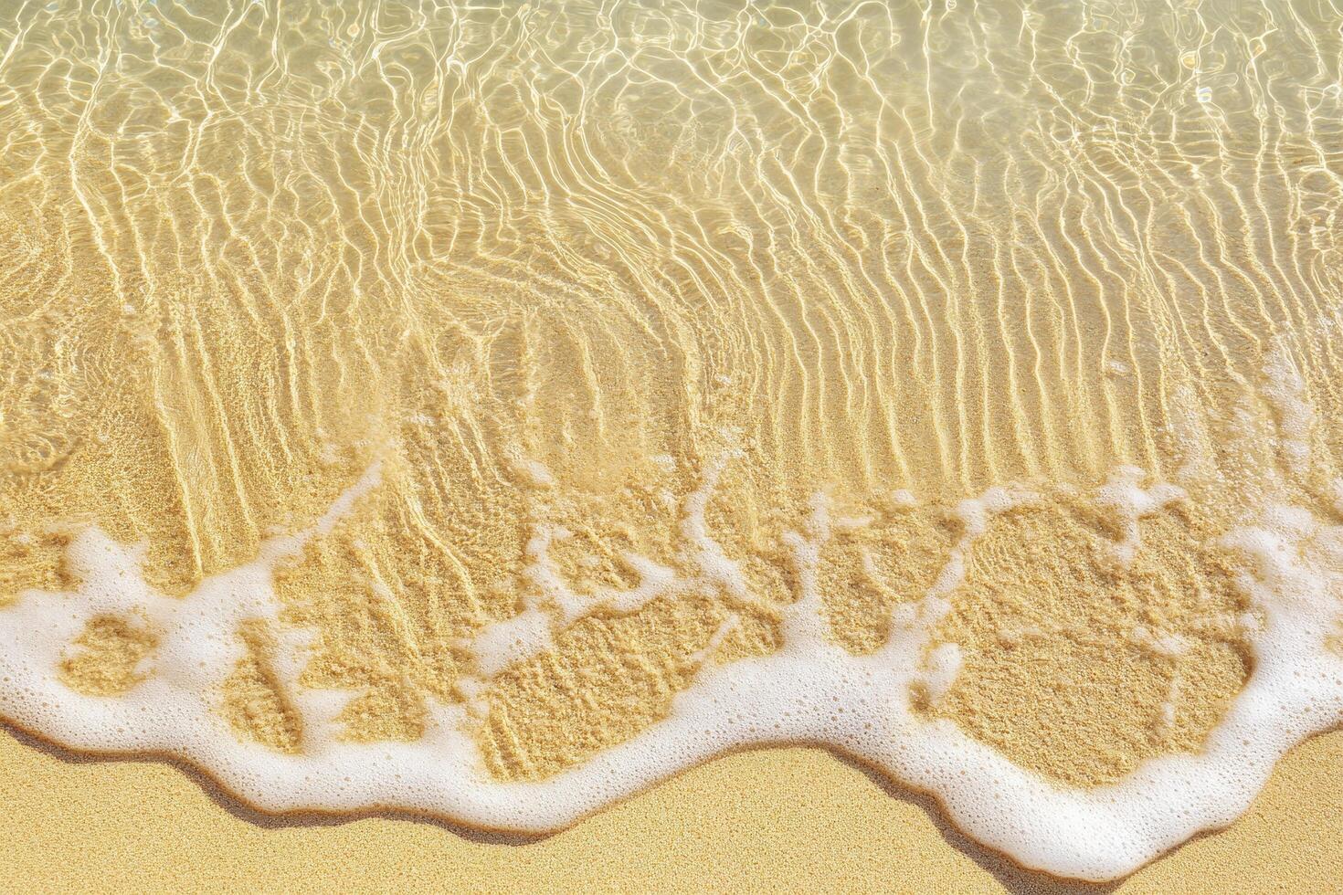 Foamy Wave Edge with Light Reflecting on Sandy Seabed photo
