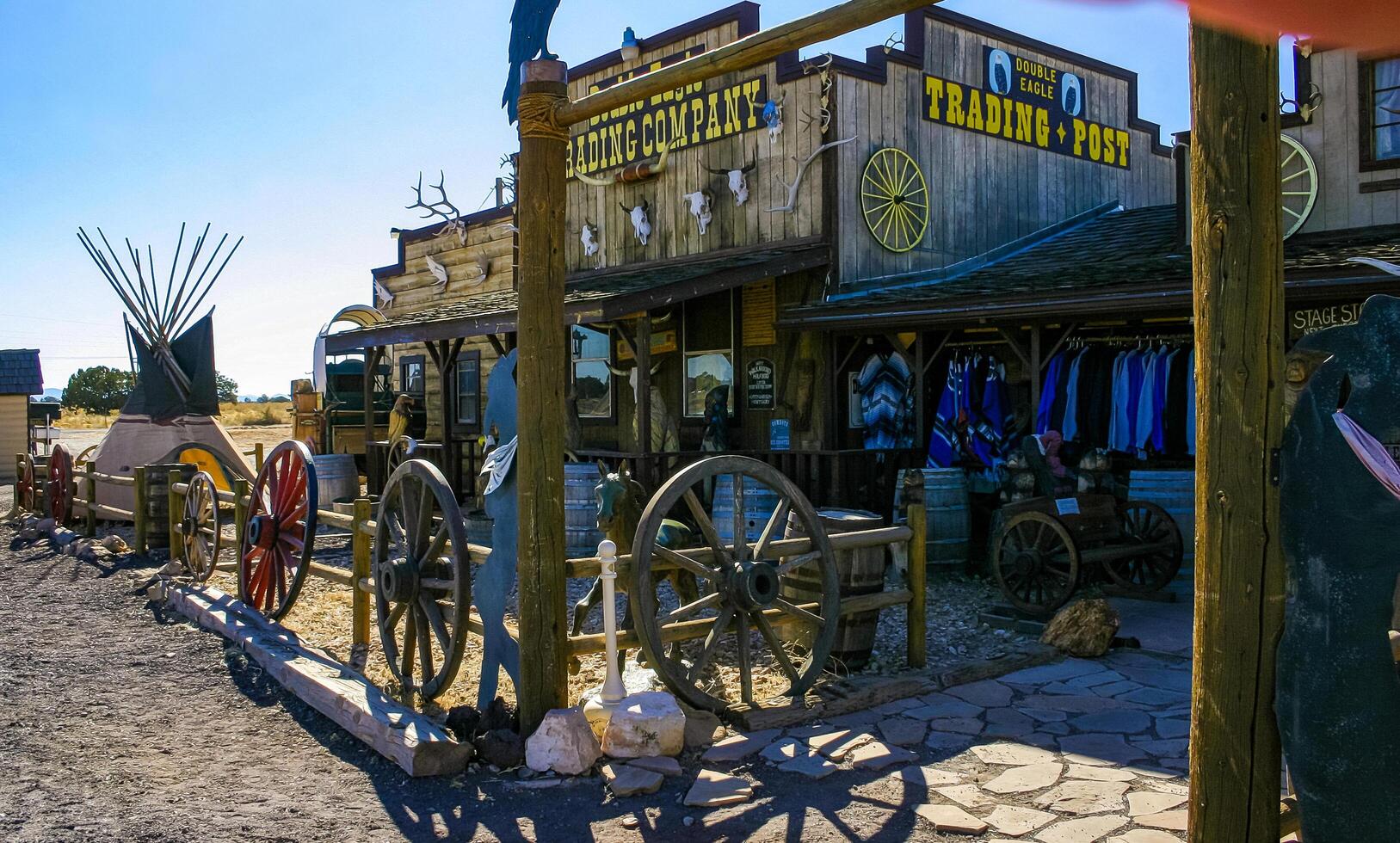 Arizona, USA - November 27, 2009 Rustic wooden saloon flanked by a traditional teepee and vintage barrels in a western setting photo