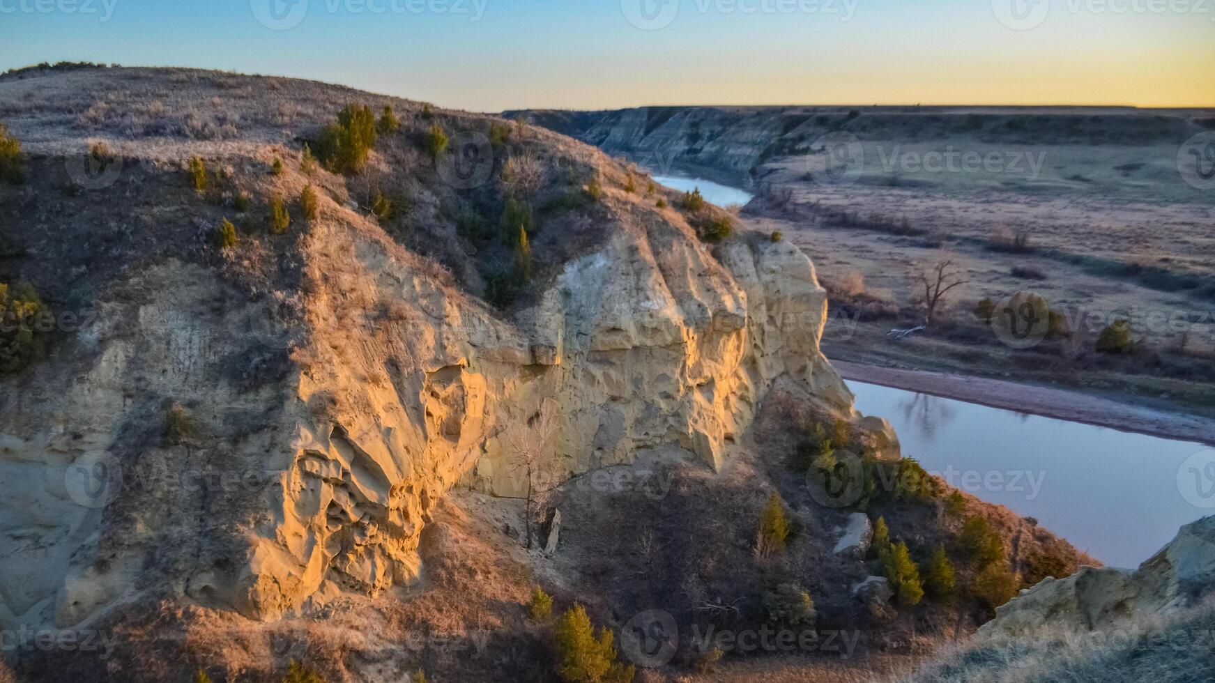 View of the winding river from the mountain in the evening at sunset. North Dakota photo