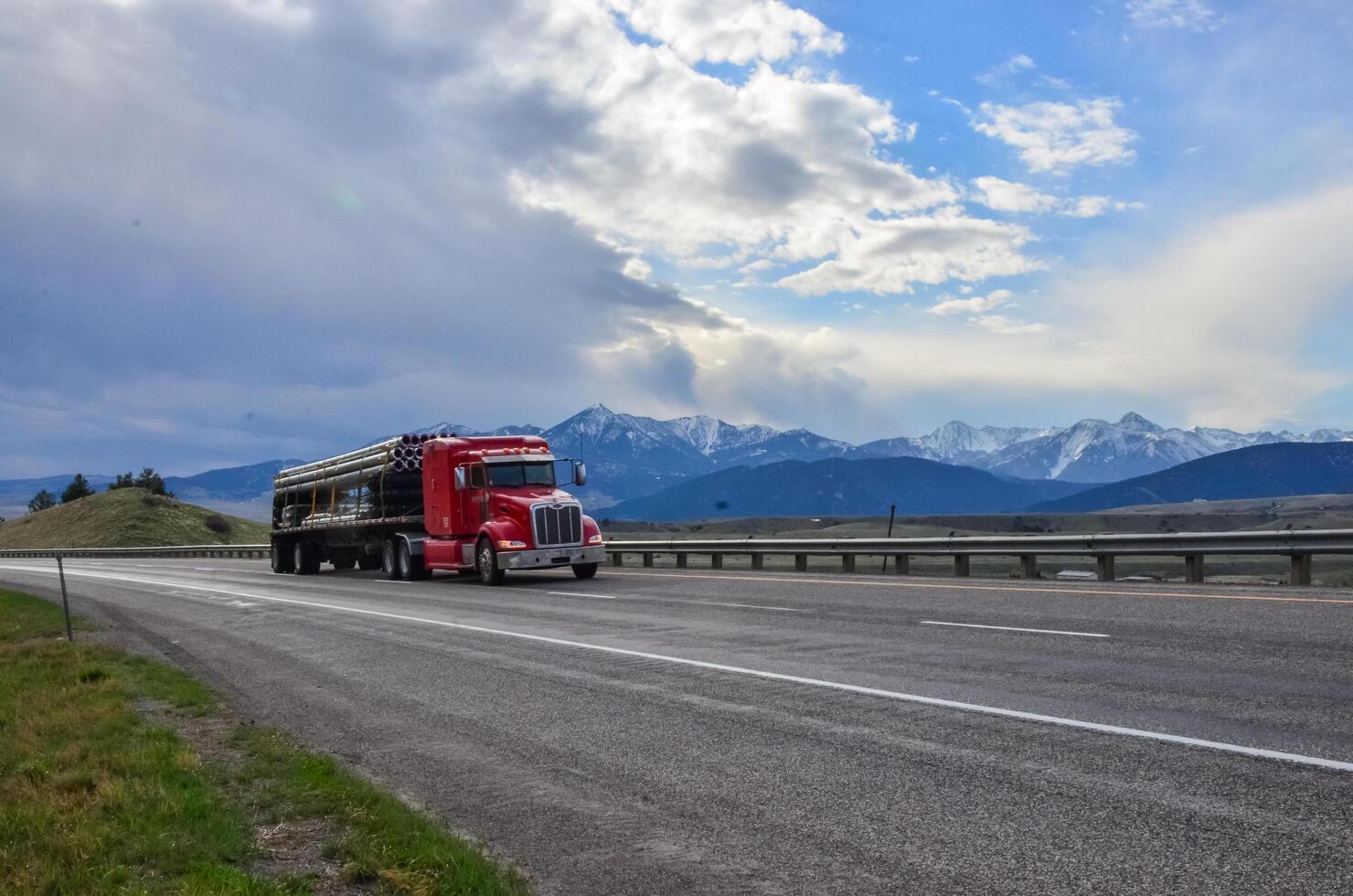 USA, MONTANA - APRIL 28, 2018 Car on an asphalt road against the sky, white clouds on the horizon photo