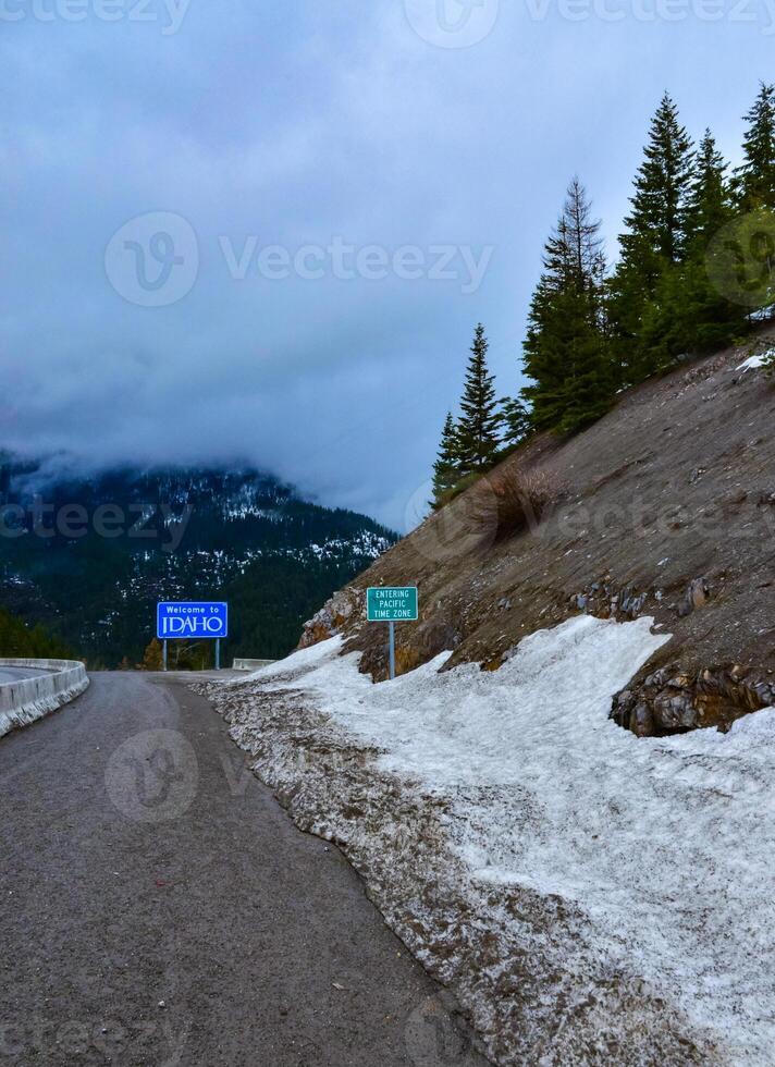 Snowy forest. Information sign on the background of coniferous trees photo