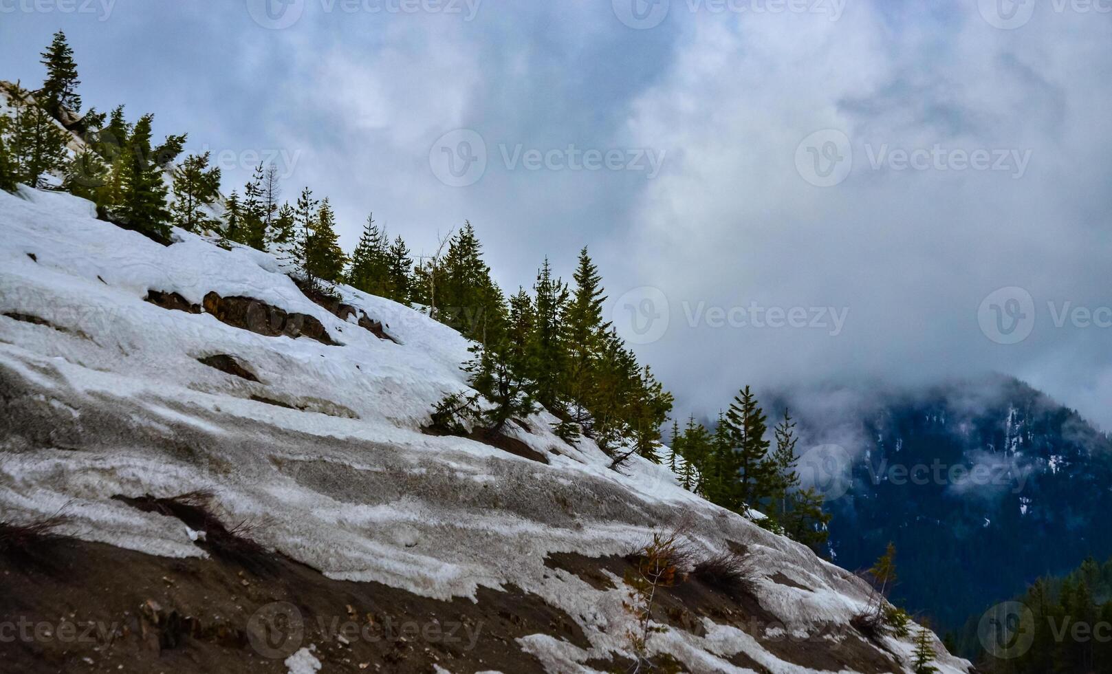 Snow in the mountains at the end of winter, snow melting in the mountains. Mountain landscape. photo