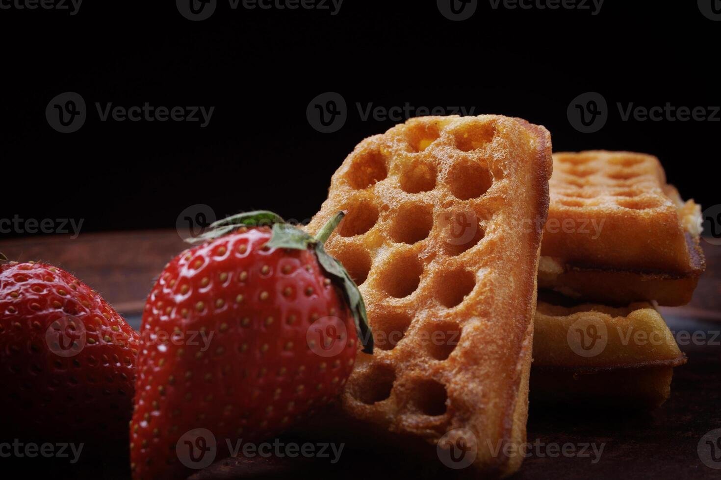 Viennese waffles in the shape of a heart lie on a clay plate. Viennese waffles with strawberries. photo