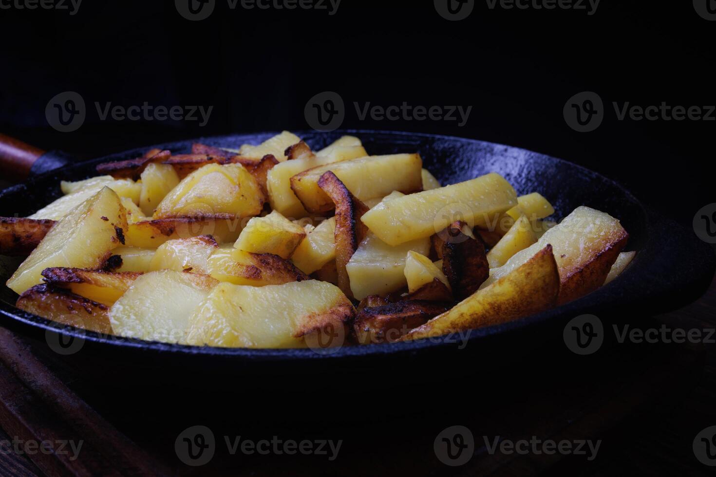 Roasted potatoes. Potatoes fried in butter in a cast iron frying pan. photo