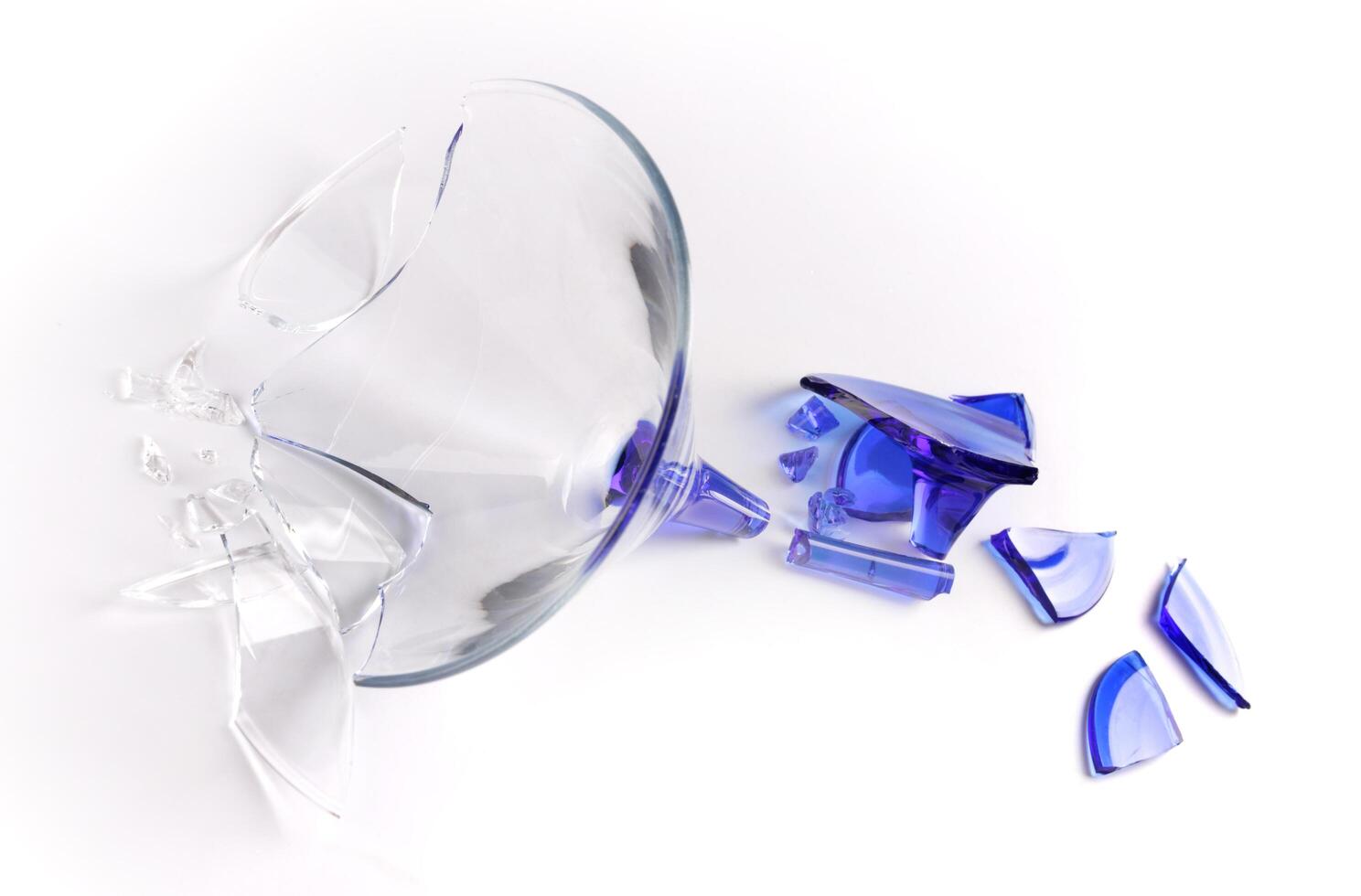 Broken wine glass on a white background. photo