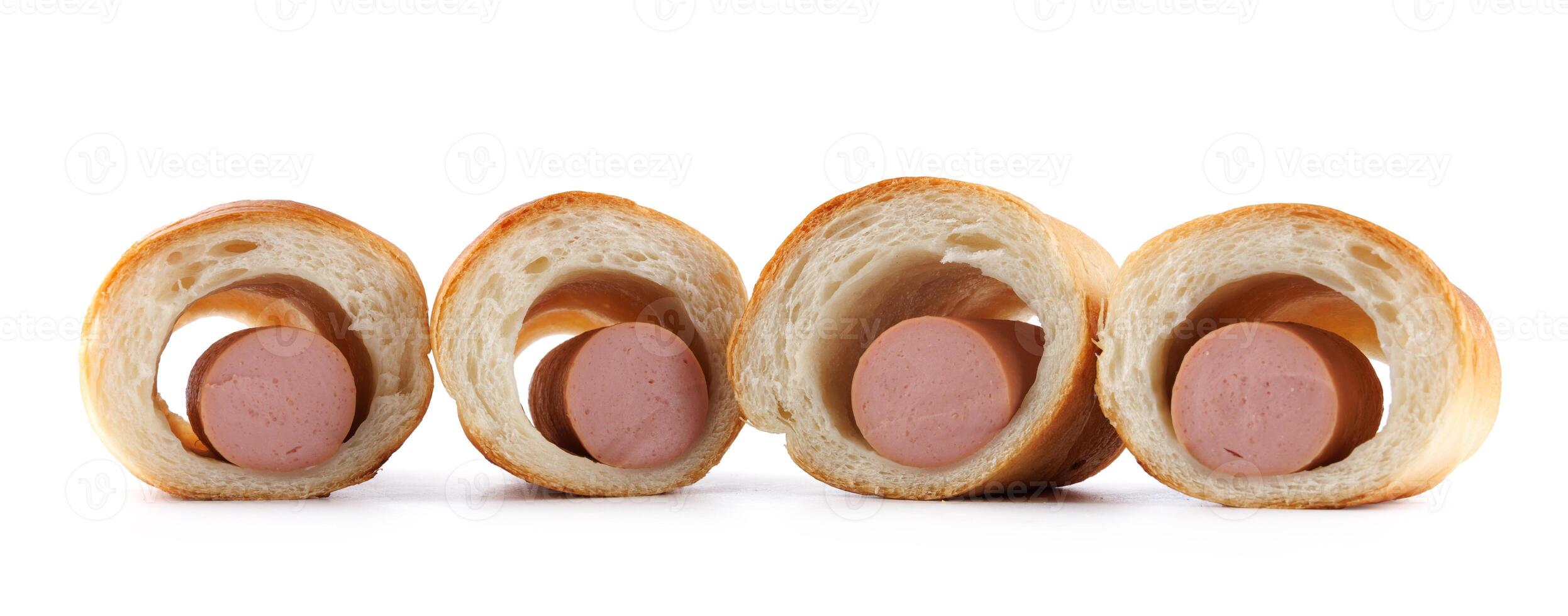 Sausages in dough cut in half isolated on a white background.Sausage in dough. photo