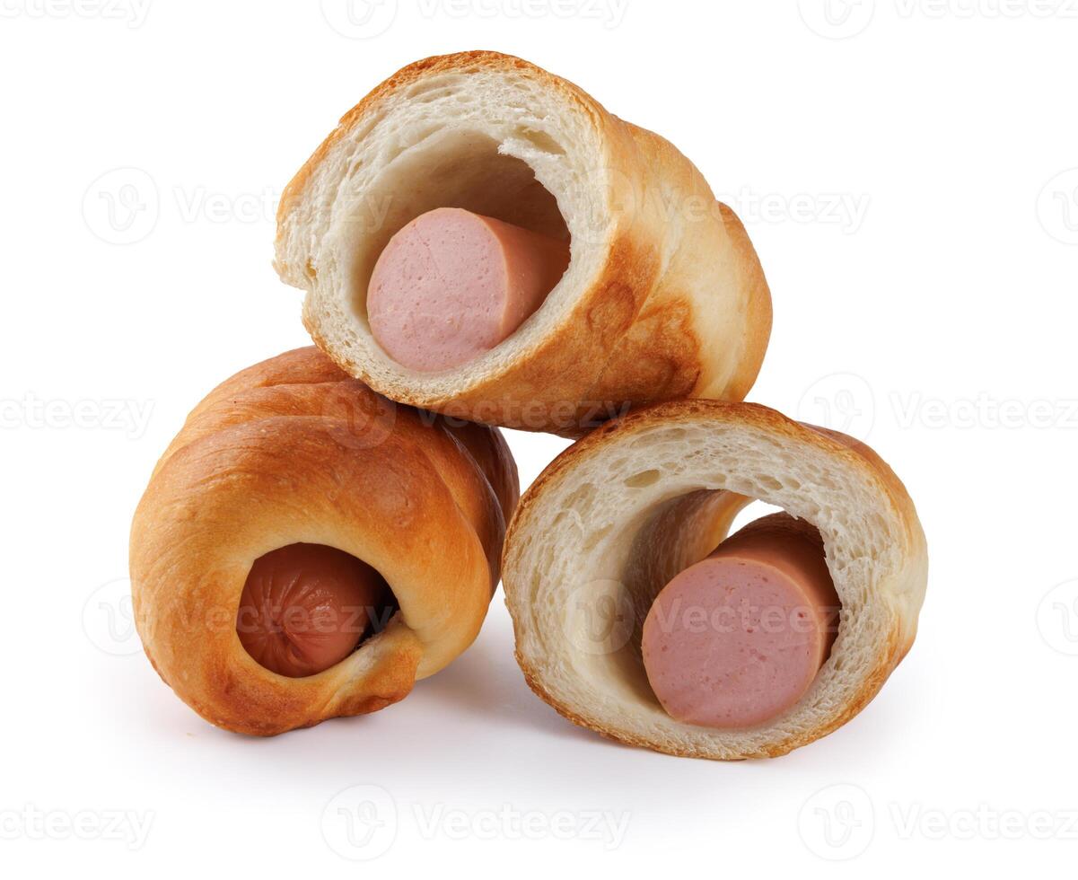 Whole and halved sausages in dough isolated on a white background. photo
