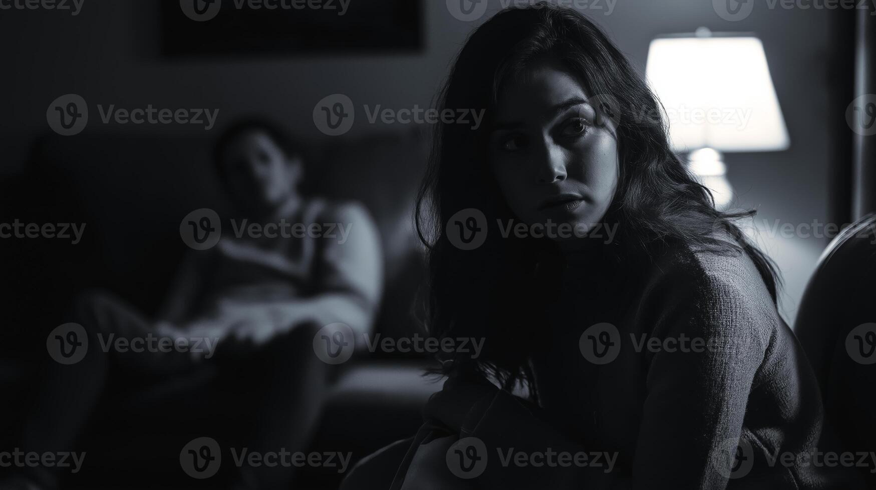 Evening Scene of Concerned Woman with Distant Man Under Soft Lamp Light in Living Room Emotional Moments photo