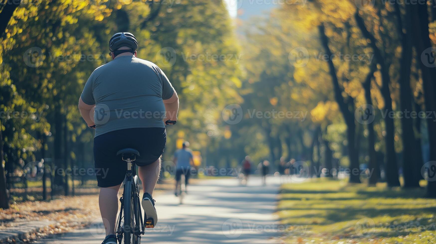 Obese Man Riding a Bicycle in Park, Outdoor Exercise for Health and Wellness, Autumn Day in Nature photo