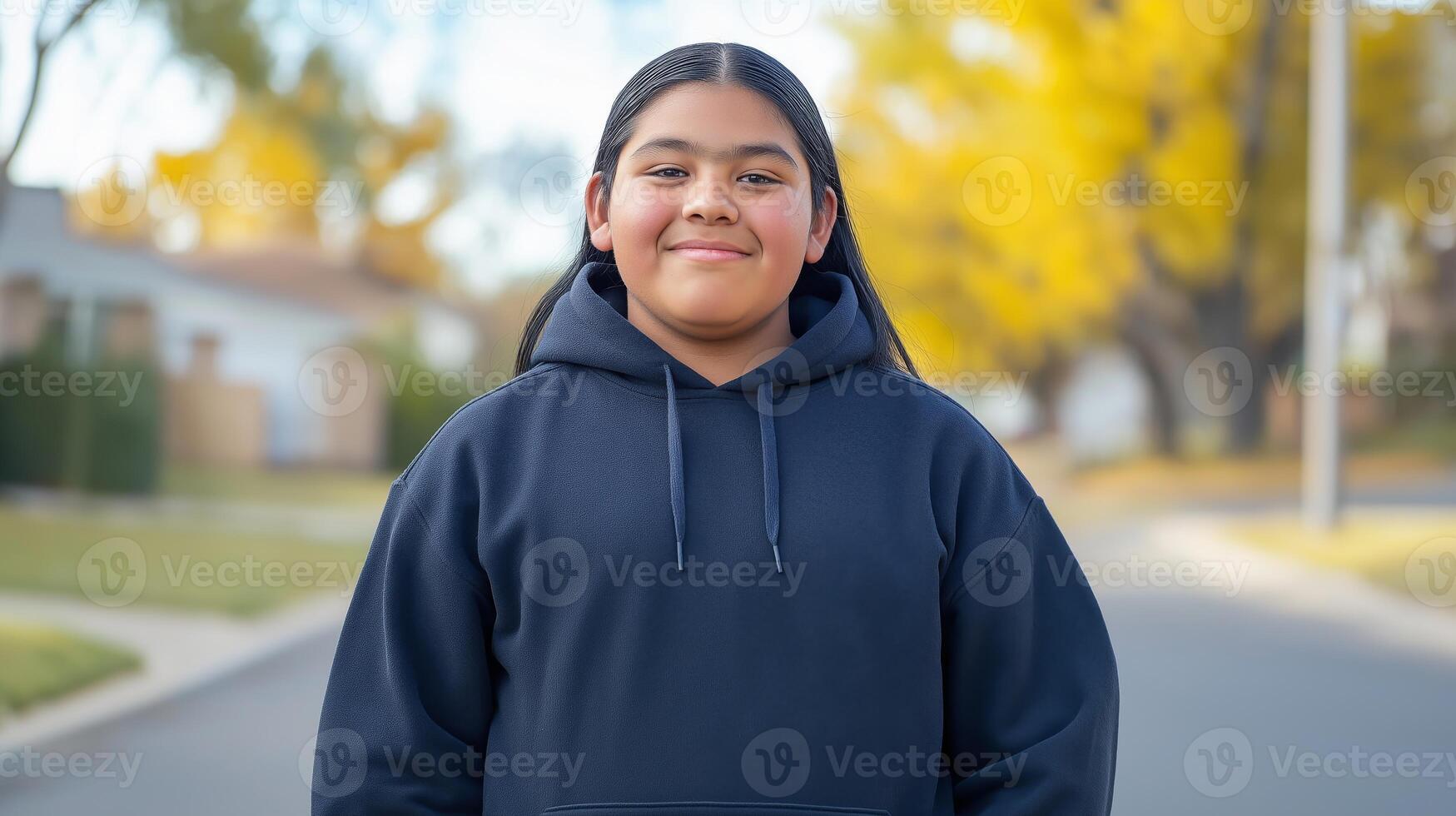 Smiling Teenage Native American Boy Outdoors in Autumn, Wearing Black Hoodie, Neighborhood with Fall Foliage Background photo