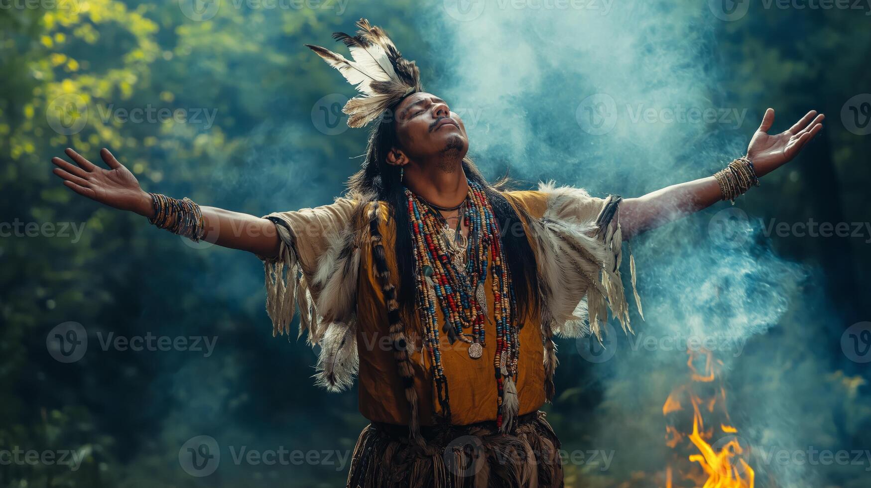 Traditional Shaman Performing Ceremonial Dance in Tribal Costume in Woodland Setting photo