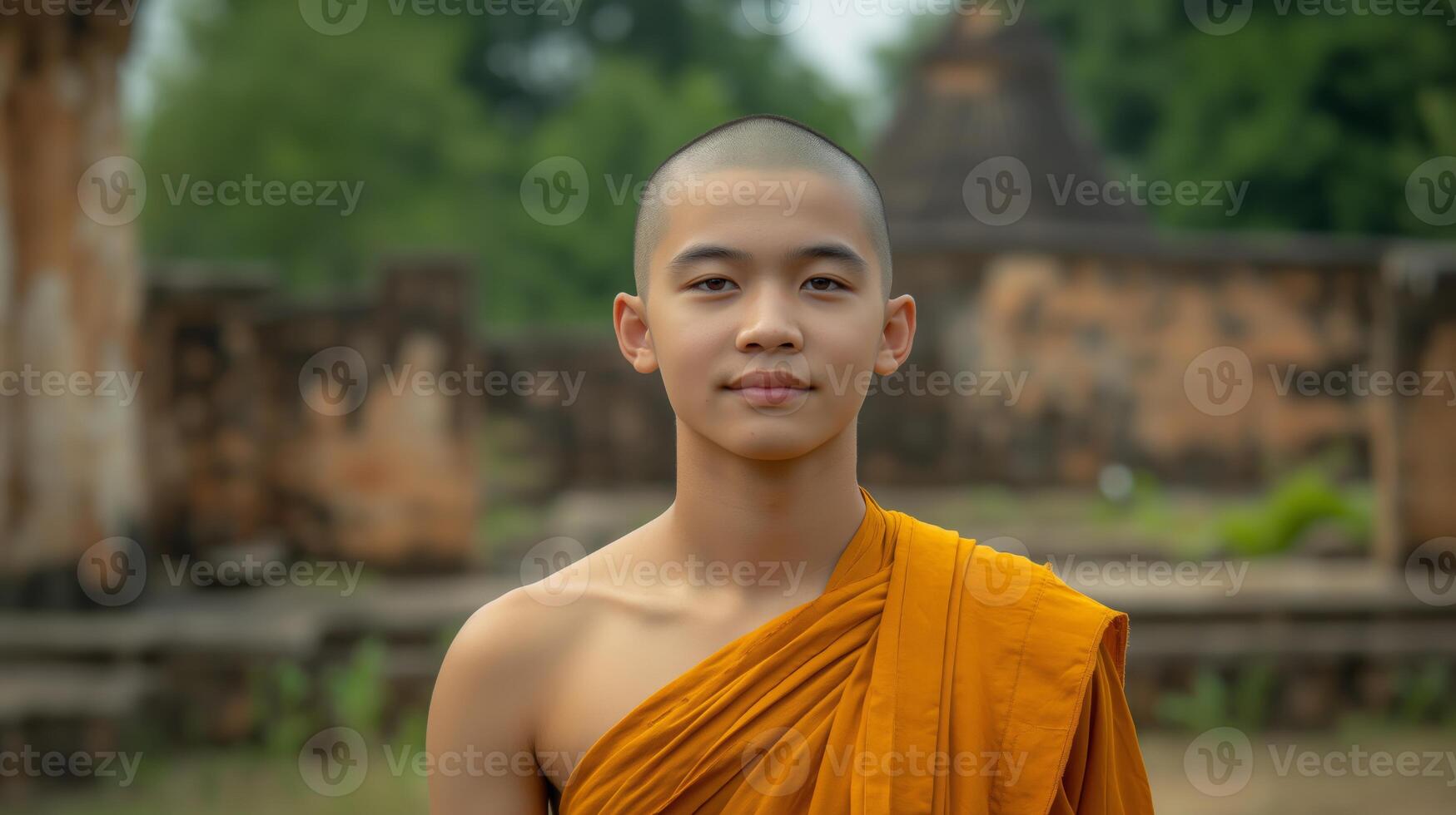 Tranquil Young Buddhist Monk in Traditional Orange Robe at Ancient Temple Grounds photo